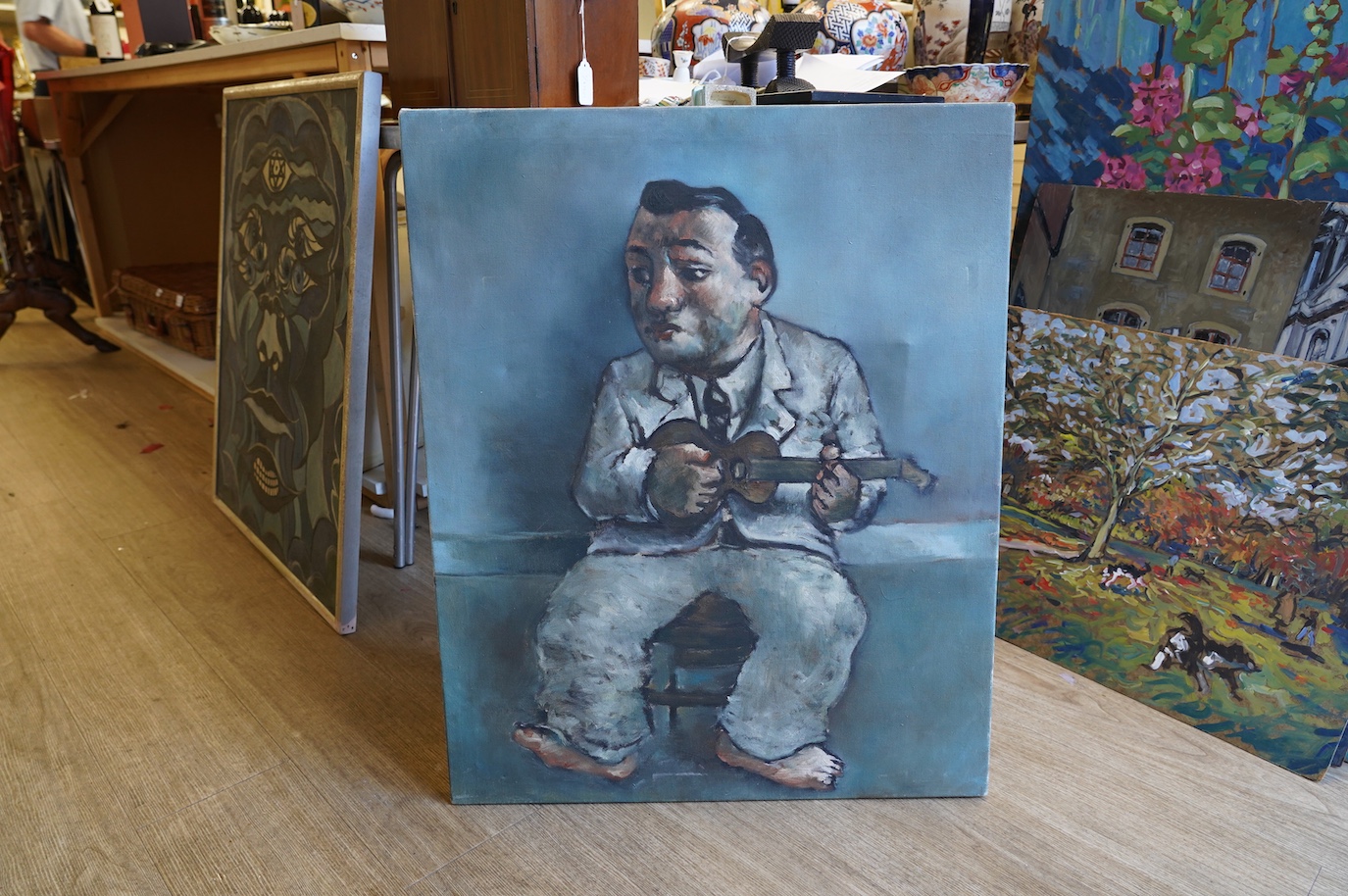 Stylised oil on canvas, Study of a ukelele player, unsigned, 78 x 64cm. Condition - fair to good